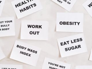 Collection of motivational quotes promoting health and wellness on paper cards.