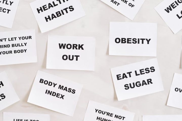 Collection of motivational quotes promoting health and wellness on paper cards.